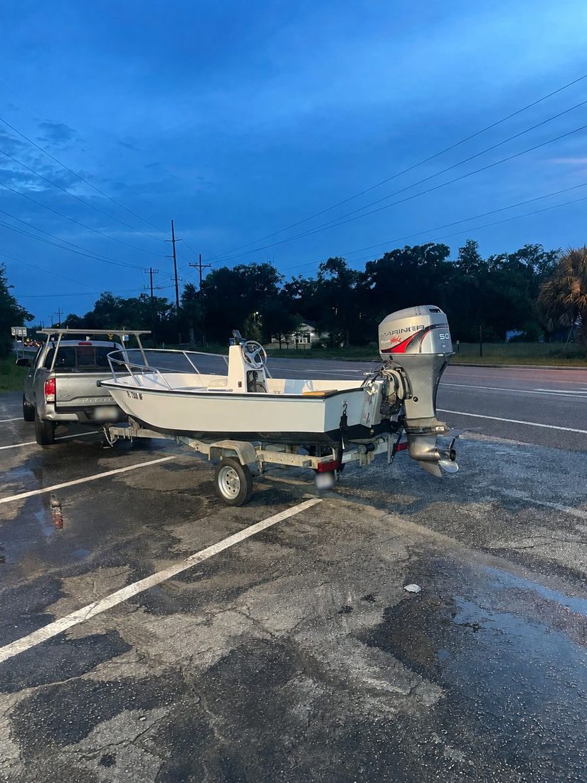 Mobile marine service — our truck and a customer's boat on its trailer at dusk